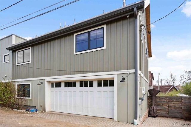700 Cheyenne St, Golden, CO 80401 - view of front facade featuring board and batten siding, an attached garage, and fence