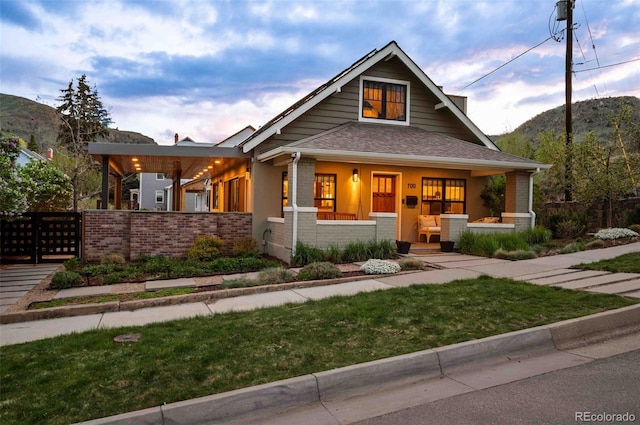 700 Cheyenne St, Golden, CO 80401 - craftsman inspired home with brick siding, a mountain view, fence, and covered porch
