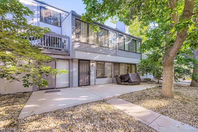 15047 E Louisiana Dr Unit A, Aurora, CO 80012 - view of front facade featuring a balcony and a patio area