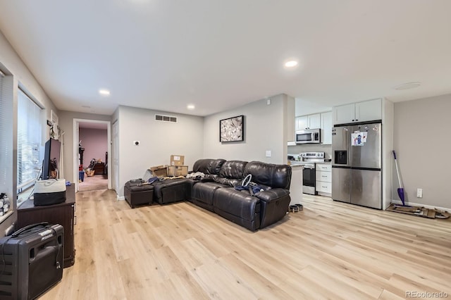 15047 E Louisiana Dr Unit A, Aurora, CO 80012 - living room featuring light wood-style flooring and recessed lighting