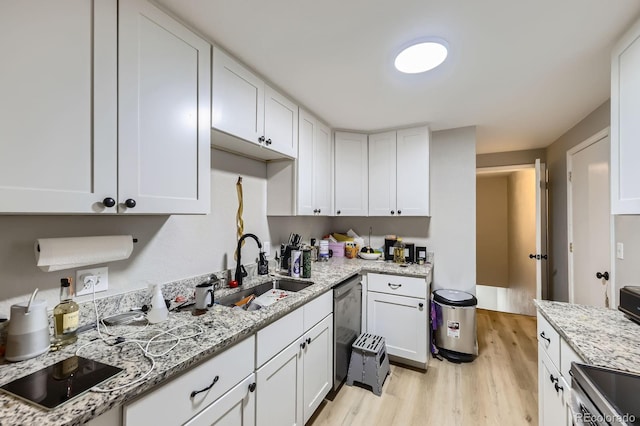 15047 E Louisiana Dr Unit A, Aurora, CO 80012 - kitchen with appliances with stainless steel finishes, white cabinets, light wood finished floors, and light stone countertops