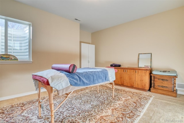 bedroom featuring light carpet