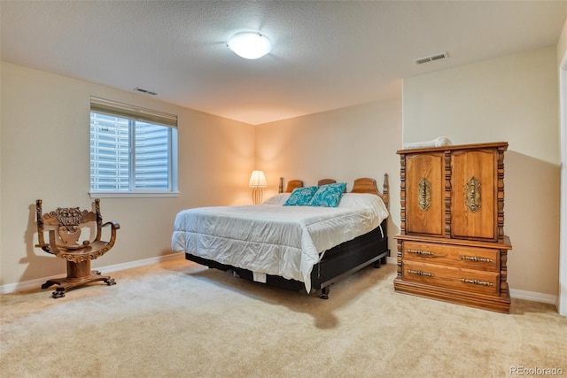 carpeted bedroom with a textured ceiling