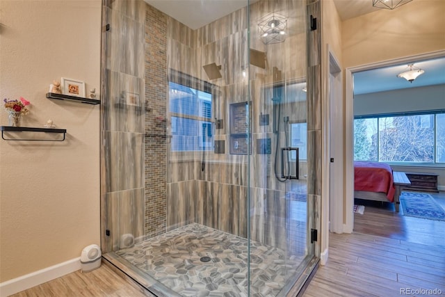 bathroom featuring hardwood / wood-style floors and an enclosed shower