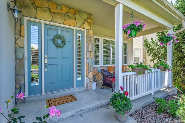 14878 E Aberdeen Ave, Centennial, CO 80016 - view of exterior entry featuring stone siding and a porch