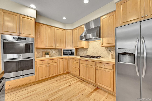 14878 E Aberdeen Ave, Centennial, CO 80016 - kitchen with stainless steel appliances, wall chimney range hood, light wood finished floors, light brown cabinetry, and recessed lighting