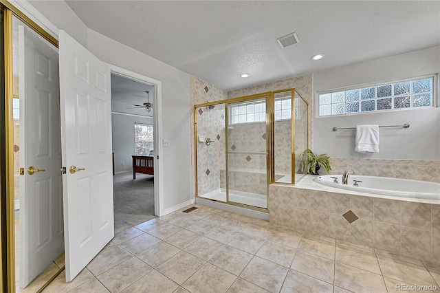 14878 E Aberdeen Ave, Centennial, CO 80016 - bathroom with tile patterned floors, a bath, a shower stall, recessed lighting, and a textured ceiling