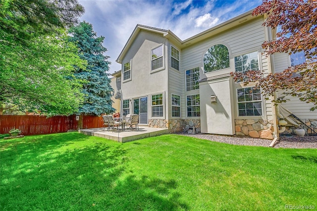 14878 E Aberdeen Ave, Centennial, CO 80016 - back of house featuring a patio, stone siding, and stucco siding