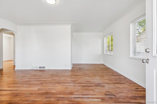 4624 S Lincoln St, Englewood, CO 80113 - empty room with arched walkways, wood finished floors, and baseboards