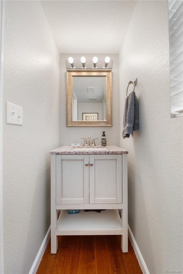 15353 E 98th Pl, Commerce City, CO 80022 - bathroom featuring wood finished floors and vanity