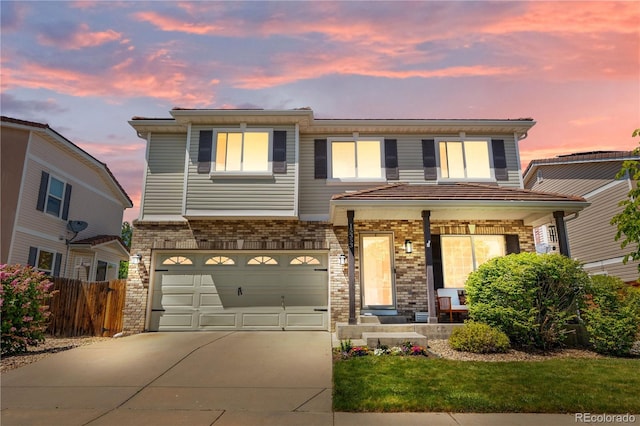 15353 E 98th Pl, Commerce City, CO 80022 - view of front of property featuring concrete driveway, an attached garage, a porch, and brick siding