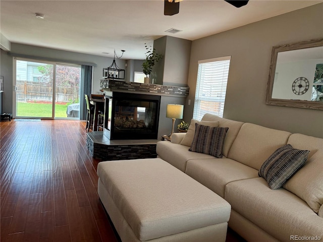 15353 E 98th Pl, Commerce City, CO 80022 - living area with dark wood-style floors and a multi sided fireplace