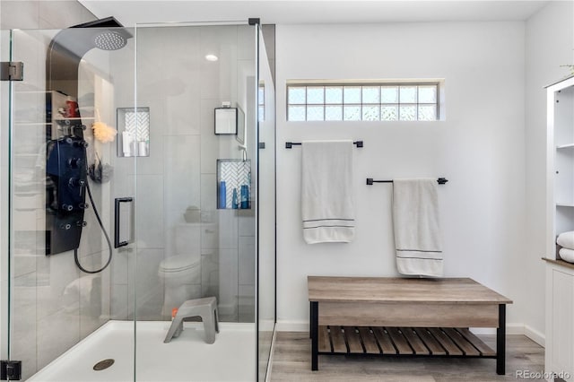 15353 E 98th Pl, Commerce City, CO 80022 - bathroom featuring wood finished floors and a shower stall