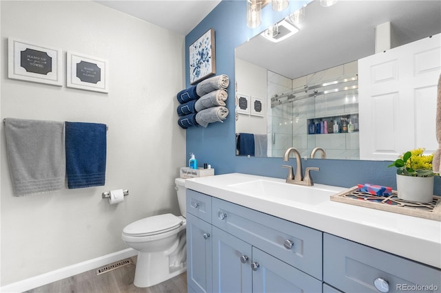 15353 E 98th Pl, Commerce City, CO 80022 - bathroom with wood finished floors, vanity, and a stall shower