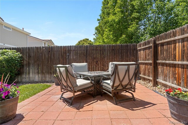 15353 E 98th Pl, Commerce City, CO 80022 - fenced backyard with a patio area and outdoor dining area