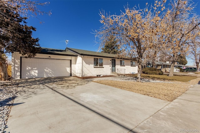 ranch-style home with a garage and driveway