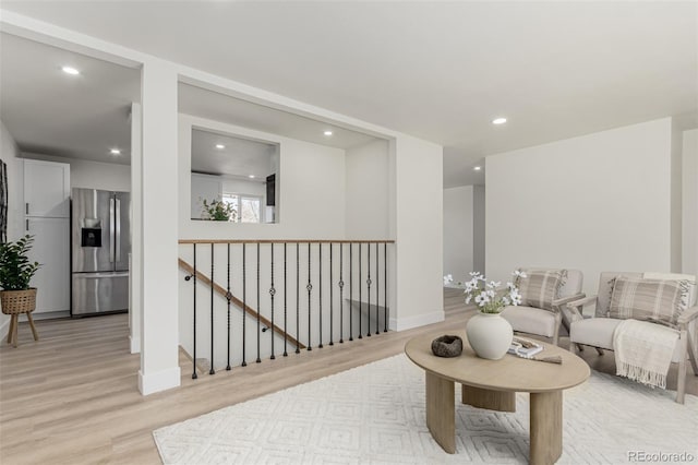 living room featuring light wood-style floors, recessed lighting, and baseboards