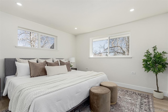 bedroom with recessed lighting, baseboards, and wood finished floors