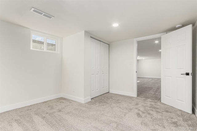 unfurnished bedroom with recessed lighting, carpet flooring, visible vents, baseboards, and a closet