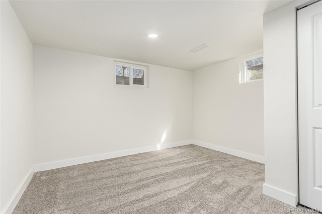 carpeted spare room with recessed lighting, plenty of natural light, and baseboards