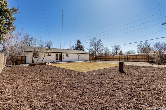 exterior space featuring a fenced backyard and a lawn