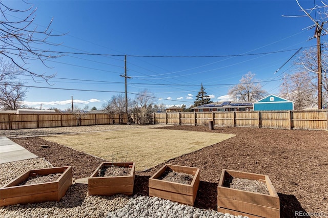 view of yard with a fenced backyard and a vegetable garden