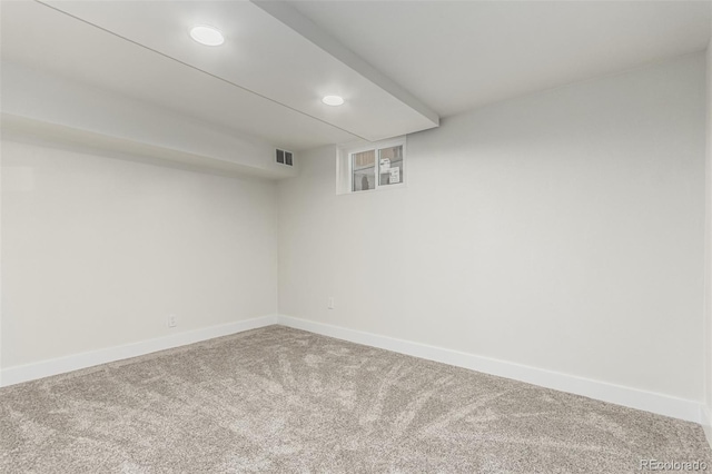 finished below grade area with recessed lighting, baseboards, visible vents, and carpet