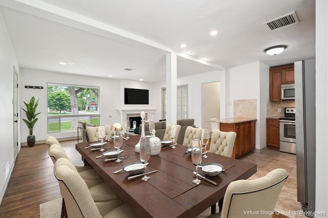 1420 S Leyden St, Denver, CO 80224 - dining space with light wood-type flooring, a fireplace, baseboards, and recessed lighting