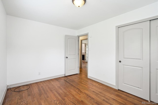 1420 S Leyden St, Denver, CO 80224 - unfurnished bedroom with baseboards, wood finished floors, and a closet