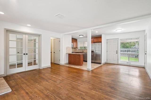 1420 S Leyden St, Denver, CO 80224 - unfurnished living room with wood finished floors, healthy amount of natural light, french doors, recessed lighting, and baseboards