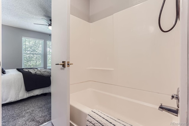 bathroom featuring a textured ceiling, ceiling fan, and shower / washtub combination