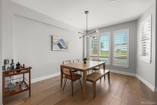 4535 W 50th Ave, Denver, CO 80212 - dining space featuring baseboards, wood finished floors, and a chandelier