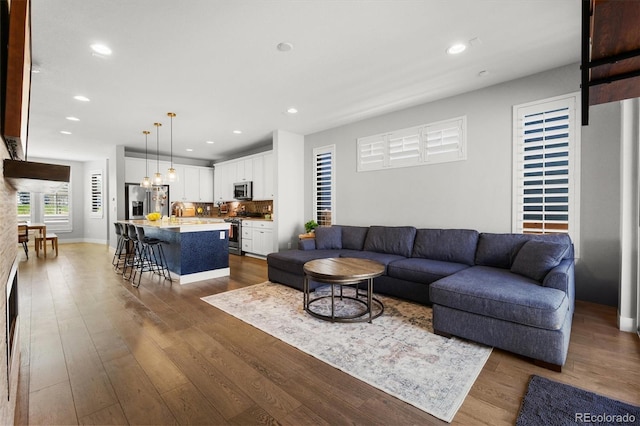 4535 W 50th Ave, Denver, CO 80212 - living area with wood finished floors, recessed lighting, and baseboards