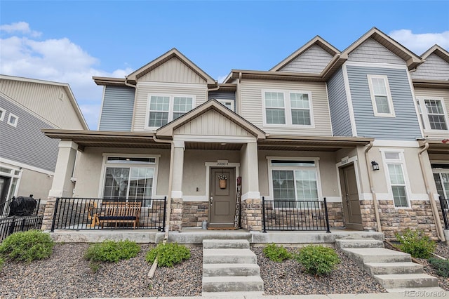20000 E 40th Ave Unit 4, Denver, CO 80249 - view of front of home with a porch, stone siding, board and batten siding, and stucco siding