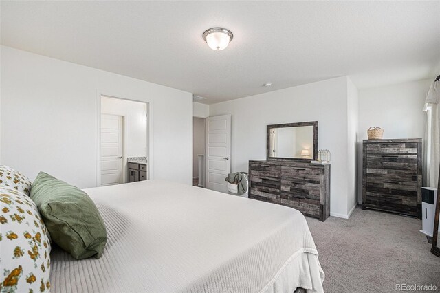 20000 E 40th Ave Unit 4, Denver, CO 80249 - carpeted bedroom with baseboards and ensuite bathroom