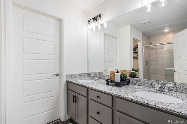 20000 E 40th Ave Unit 4, Denver, CO 80249 - bathroom featuring double vanity and a shower stall