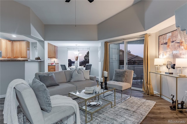 living room featuring dark wood-type flooring and ceiling fan