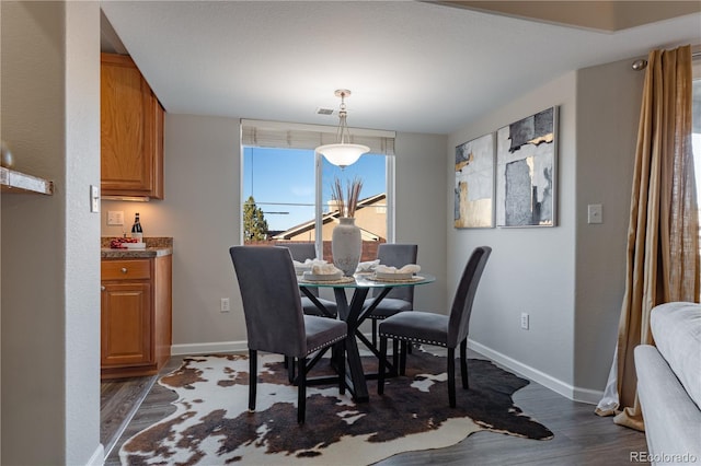 dining area featuring dark hardwood / wood-style floors