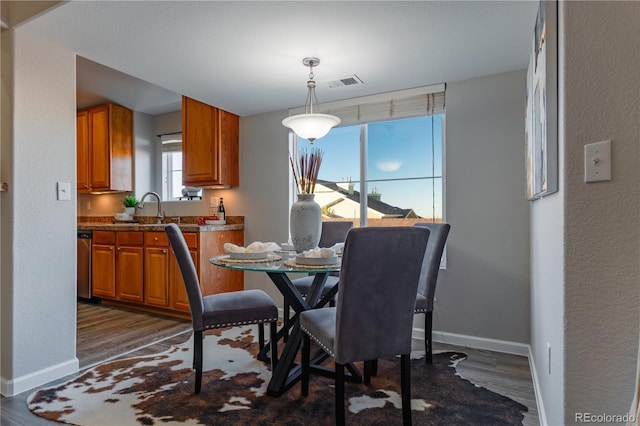 dining room featuring dark hardwood / wood-style floors and sink