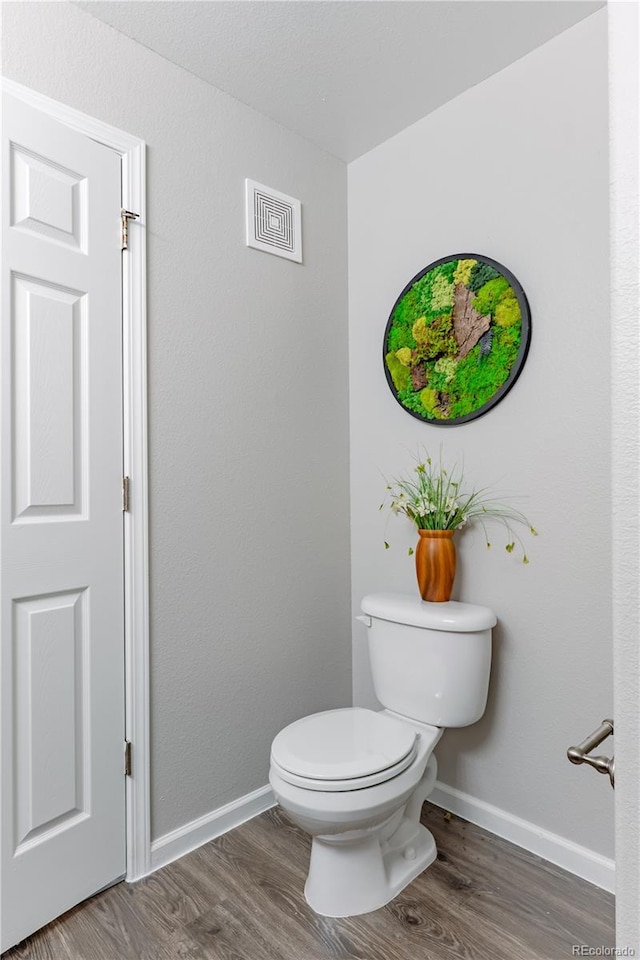 bathroom featuring toilet and hardwood / wood-style floors