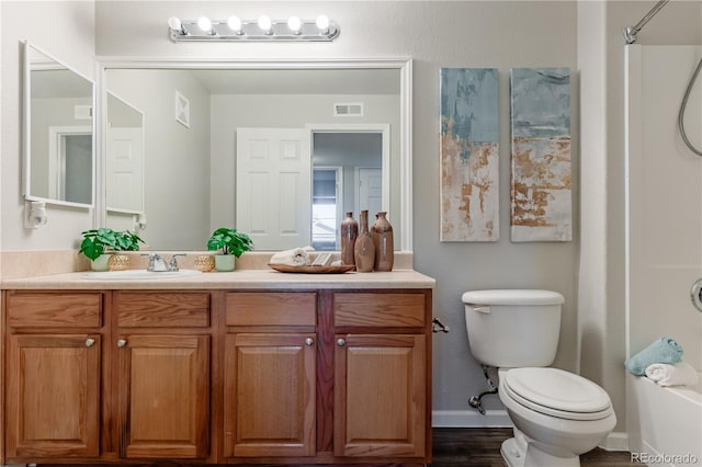 full bathroom featuring vanity, toilet, tub / shower combination, and hardwood / wood-style floors