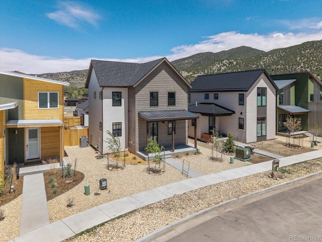 126 Chase St, Salida, CO 81201 - view of front of home with a mountain view, metal roof, a standing seam roof, stucco siding, and covered porch