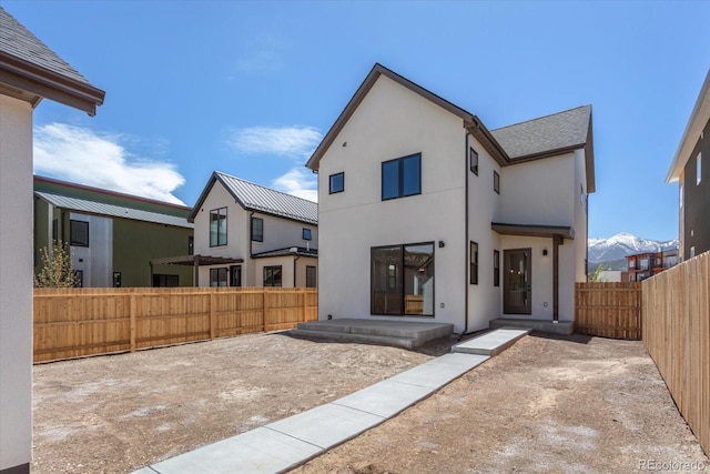126 Chase St, Salida, CO 81201 - back of property featuring a fenced backyard, stucco siding, and a shingled roof