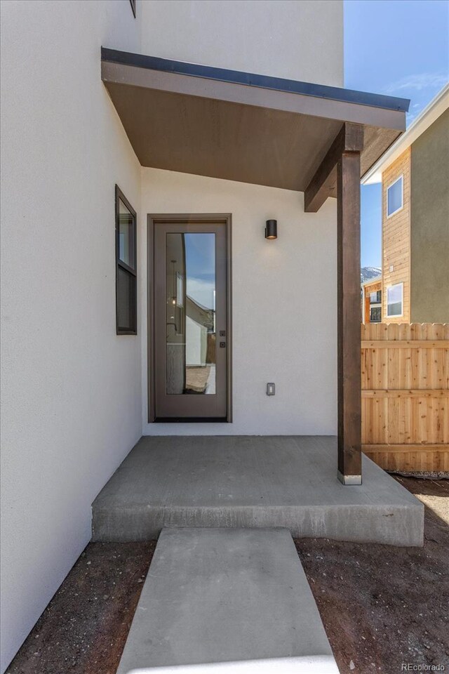 126 Chase St, Salida, CO 81201 - view of exterior entry with stucco siding and fence
