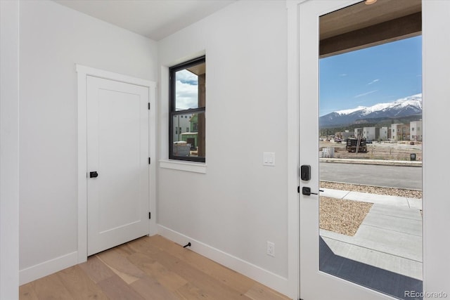 126 Chase St, Salida, CO 81201 - doorway with wood finished floors, a mountain view, and baseboards