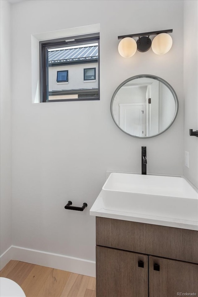126 Chase St, Salida, CO 81201 - bathroom with wood finished floors, baseboards, and vanity