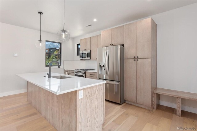 126 Chase St, Salida, CO 81201 - kitchen featuring appliances with stainless steel finishes, a sink, light wood finished floors, baseboards, and recessed lighting