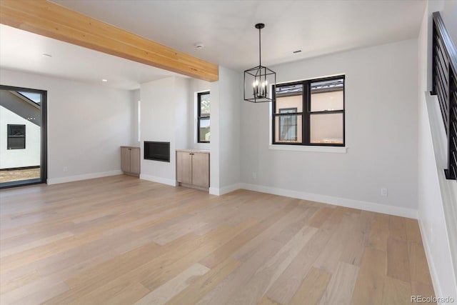 126 Chase St, Salida, CO 81201 - unfurnished living room featuring a chandelier, light wood finished floors, and baseboards