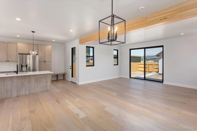 126 Chase St, Salida, CO 81201 - unfurnished living room featuring a chandelier, recessed lighting, light wood-type flooring, a sink, and baseboards
