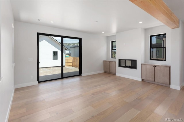 126 Chase St, Salida, CO 81201 - unfurnished living room featuring light wood-style flooring, recessed lighting, baseboards, and a glass covered fireplace